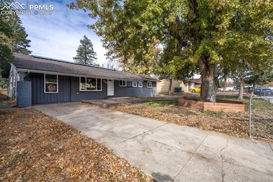 Ranch-style house featuring covered porch, roof with shingles, and brick siding
