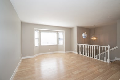 Spare room featuring light wood-style floors and a chandelier
