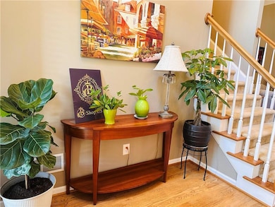 Bar featuring wood finished floors, baseboards, an