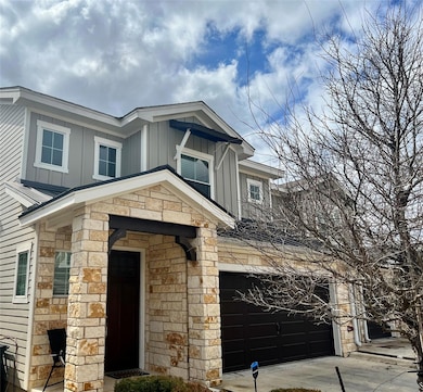 View of front of property featuring stone siding,