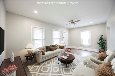 Living room with wood finished floors, ceiling fan, and recessed lighting