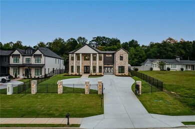 View of front of home with stone siding, driveway, and a fenced front yard