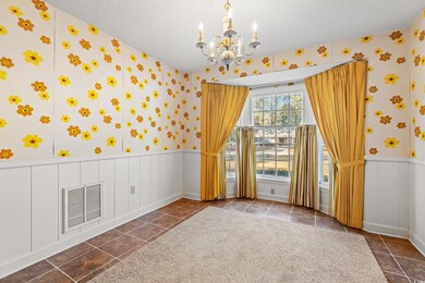 Tiled empty room featuring a textured ceiling and 
