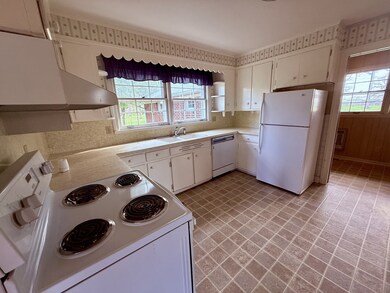 The kitchen has a stove, refrigerator & NEW dishwasher.