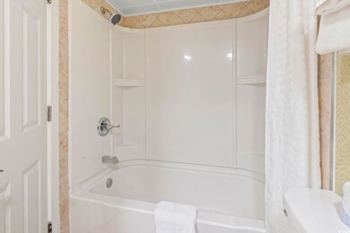 Bathroom featuring shower / tub combo with curtain