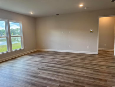 Spare room with baseboards, wood finished floors, recessed lighting, and a smoke detector