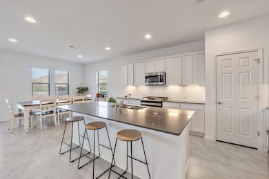 Kitchen featuring white cabinetry, tasteful backs