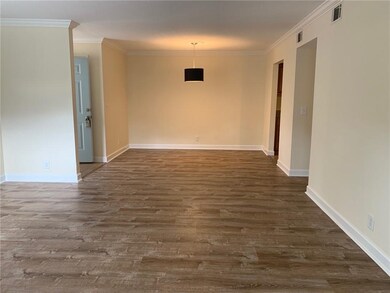 View from sunroom into living room and dining area