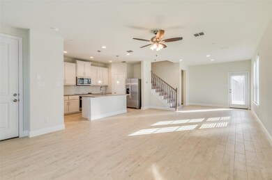 Unfurnished living room featuring sink, ceiling fa
