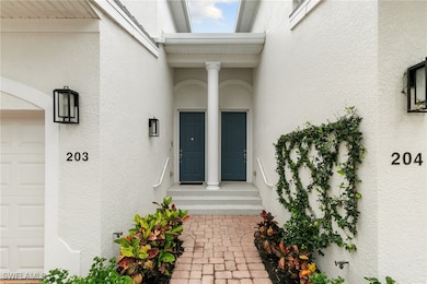 View of exterior entry featuring a garage and stuc