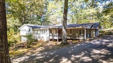 View of front of house featuring view of scattered trees