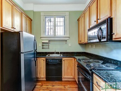 Kitchen with hardwood floor and fully equipped wit