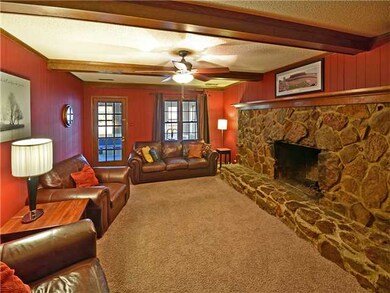 Large family room with carpet, stone/wood burning 