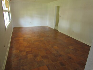 Unfurnished room featuring dark parquet floors