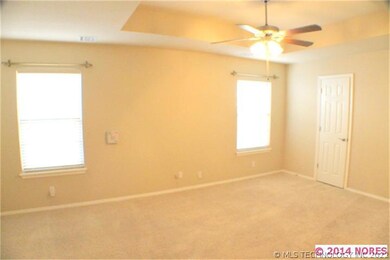 The master bedroom has a  beautiful tray ceiling,
