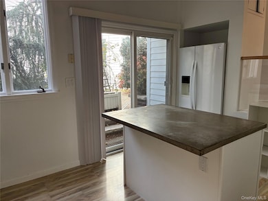 Kitchen featuring a kitchen island, and white cabinetry
