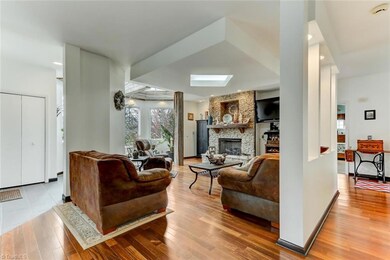 Open Living Room with Hardwoods, Stone Fireplace w/Mantle