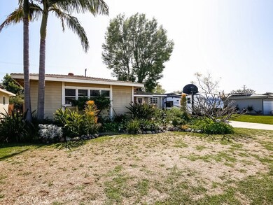 Left corner front view of home with a bigger showing of landscape.