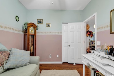 Sitting room featuring dark wood-type flooring