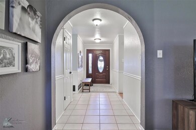 Tiled entrance foyer with crown molding