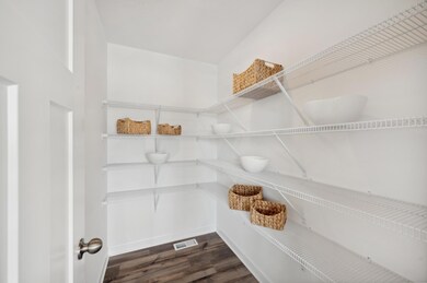 (Photo of model home, finishes will vary) The kitchen pantry.