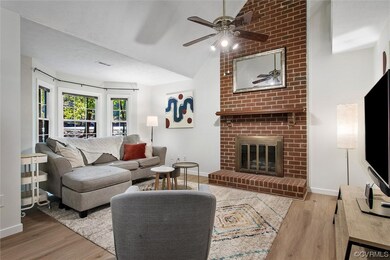 Living room with ceiling fan, lofted ceiling, ligh