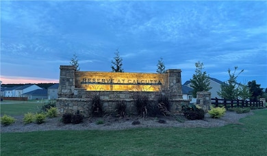 Community sign featuring a lawn