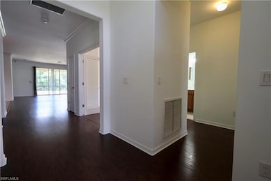 Hall featuring dark wood-style floors
