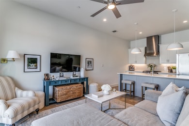 Living room featuring ceiling fan and hardwood / wood-style flooring