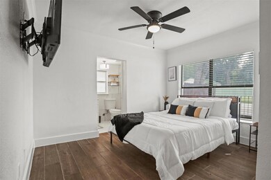 Bedroom with ceiling fan, dark hardwood / wood-sty