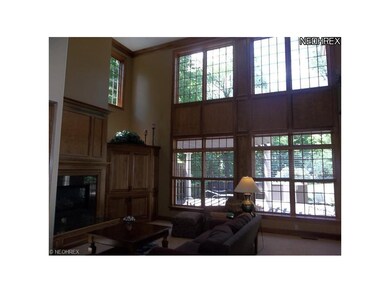 Two story family room w/ floor to ceiling windows,