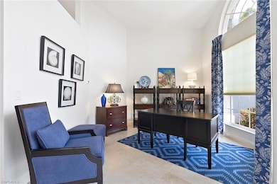 Office space featuring a high ceiling and baseboards