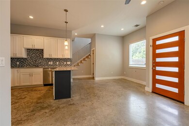 Kitchen with dishwasher, finished concrete floori