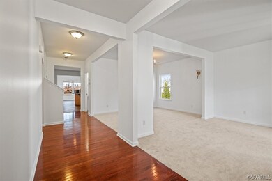 Entryway with hall through first floor past living
