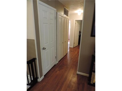 Hallway to bedrooms, coat closet and hvac