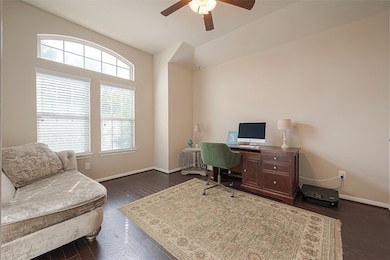 The roomy office located at the front of the house boasts ample space for productivity and comfort, complemented by large windows that flood the room with invigorating natural light.