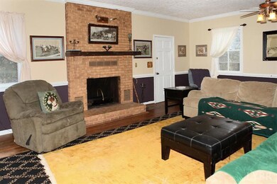 Family room fireplace and door to side fenced yard