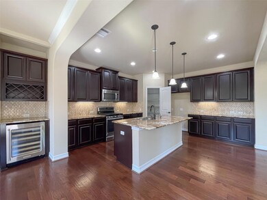 Kitchen with beverage cooler, light stone counter