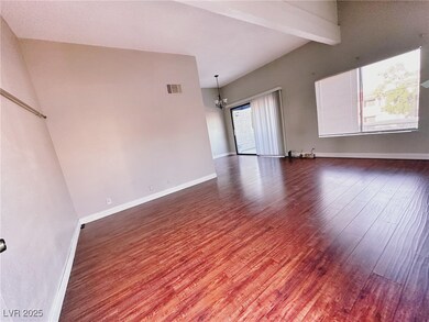 Spare room featuring wood finished floors, a chand