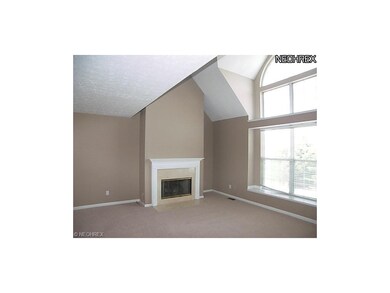 Spacious living room with fireplace and lot of lig