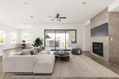 Living room featuring wood finished floors, baseb