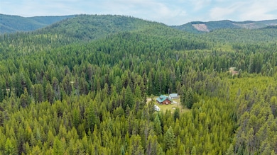 View of mountain backdrop featuring a heavily wooded area