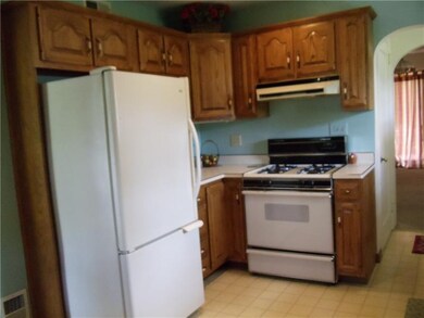 another view of kitchen cabinetry, showing refrige
