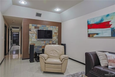 Tiled living room featuring lofted ceiling