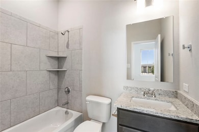 Bathroom with washtub / shower combination and vanity