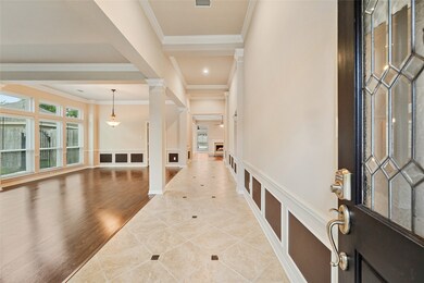Upon entering you find a welcoming corridor showcasing custom paint, beautiful floors, crown molding details, high ceilings, and ample lighting!
