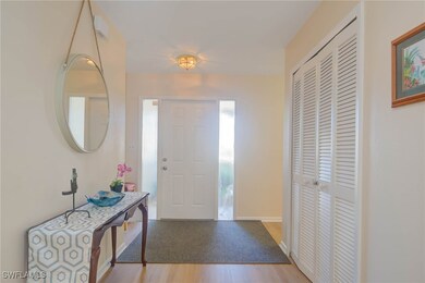 Foyer entrance with light wood-type flooring