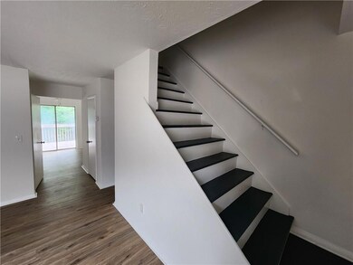 Staircase featuring wood finished floors and baseboards