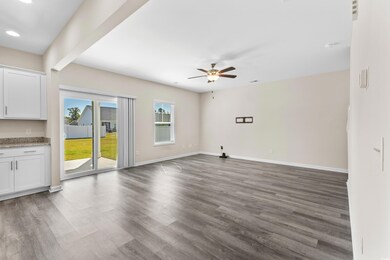 Unfurnished living room with ceiling fan and dark 