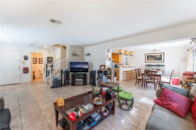 Living room with stairway, tile patterned flooring, a chandelier, and recessed lighting